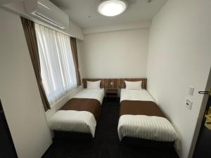 Postel nebo postele na pokoji v ubytování Ueno Urban Hotel Annex