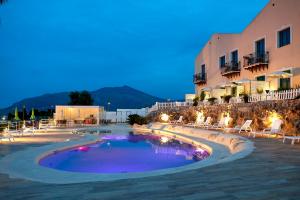 a resort with a swimming pool at night at Baglio Dello Zingaro in Scopello +37 photos