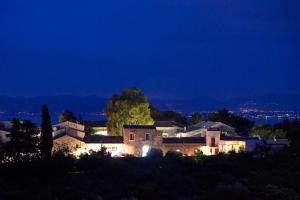 a house sitting on top of a hill at night at Baglio Dello Zingaro in Scopello