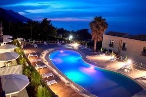 an overhead view of a swimming pool at night at Baglio Dello Zingaro in Scopello