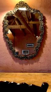 a mirror hanging on a pink wall at Montanema Handmade Village in Platanákos