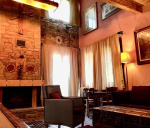 sala de estar con chimenea y pared de piedra en Montanema Handmade Village, en Platanákos