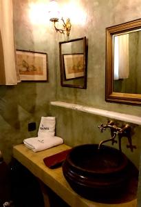 a bathroom with a sink and a mirror at Montanema Handmade Village in Platanákos