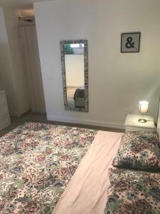 a bedroom with a bed and a mirror on the wall at Giglio Home in Catania