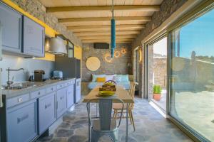 a kitchen with a counter and a table in a room at Valeria's House in Adamantas