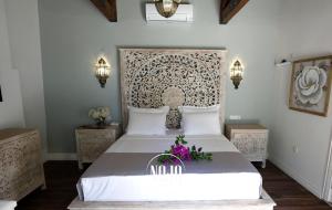 a bedroom with a large white bed with flowers on it at No 10 Hotel in Selcuk
