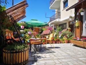 a garden center with a table and a bunch of flowers at Villa Flora in Ohrid