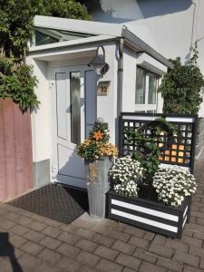 een klein huis met een blauwe deur en wat bloemen bij Ferienwohnung Ostrau in Bad Schandau