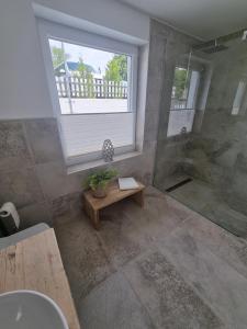 a bathroom with a shower and a sink and a window at Appartement Rakké Kiefernweg Winterberg in Winterberg +37 photos