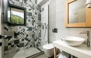 a bathroom with a sink and a toilet and a window at Marajo Suites in Skala Potamias +61 photos