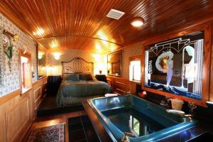 a bedroom with a bed and a tub in a room at Featherbed Railroad in Upper Lake