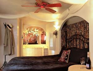 a bedroom with a bed with a ceiling fan at Featherbed Railroad in Upper Lake +7 photos