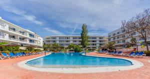 a swimming pool in a courtyard with chairs and buildings at Marina-M in Lagos