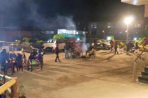a group of people sitting in a parking lot at night at Hotel Lake Paradise Mahabaleshwar in Mahabaleshwar