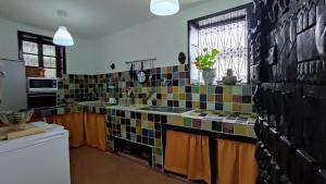 a kitchen with colorful tiles on the wall at Dar Wadada in Chefchaouene