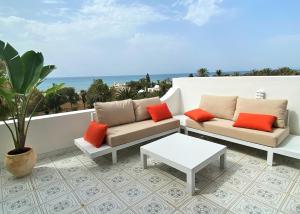 a patio with two couches and a table on a balcony at Roof Top Pied dans l'Eau Panoramic View, 80 meters from Seaside in Hammamet