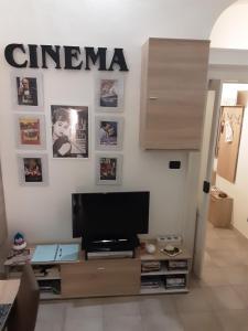 a living room with a flat screen tv on a wall at B&B Emily Brindisi in Brindisi