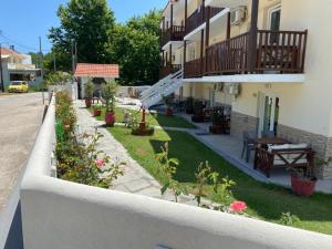 einen Balkon eines Gebäudes mit einem Hof mit Pflanzen in der Unterkunft Porto Marina in Chrisi Ammoudia