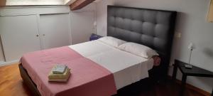 a bedroom with a large bed with a box on it at Corte Cavour. Una mansarda nel cuore della città in Ravenna