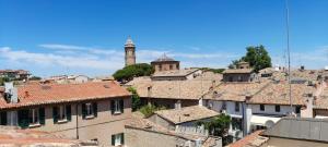a view of a city with roofs and a clock tower at Corte Cavour. Una mansarda nel cuore della città in Ravenna
