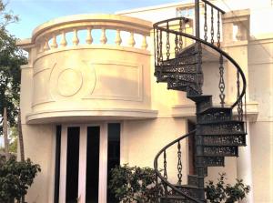 チェンナイにあるPrivate Luxury Beach Side Villaの螺旋階段を前に建つ建物