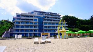 a building on the beach with two chairs and a life guard at Aurora apartments on the beach in Obzor +12 photos