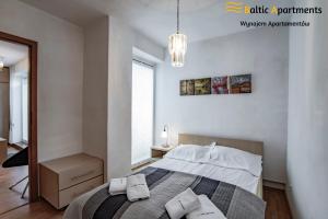Łóżko lub łóżka w pokoju w obiekcie Baltic Apartments - Rezydencja Bursztyn