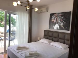 a bedroom with a bed and a picture of a woman at Apartments Blue Heaven in Ulcinj