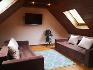 a living room with a couch and a flat screen tv at Apartament Przystań Dąbki in Dąbki