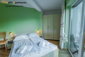 Łóżko lub łóżka w pokoju w obiekcie Baltic Apartments - Rezydencja Bursztyn