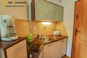 Kuchnia lub aneks kuchenny w obiekcie Baltic Apartments - Rezydencja Bursztyn
