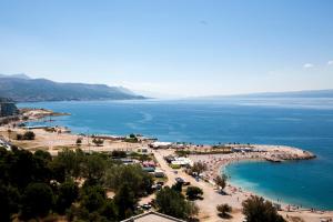 a beach with a lot of people and the water at Deluxe Beach Apartments Renata in Split