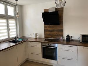 a kitchen with white cabinets and a stove top oven at Warendorf 14 in Warendorf