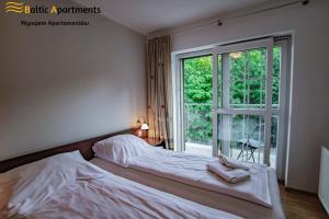 Łóżko lub łóżka w pokoju w obiekcie Baltic Apartments - Rezydencja Bursztyn