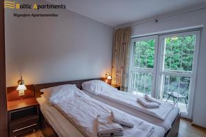 Łóżko lub łóżka w pokoju w obiekcie Baltic Apartments - Rezydencja Bursztyn
