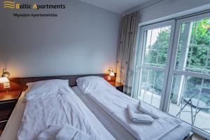 Łóżko lub łóżka w pokoju w obiekcie Baltic Apartments - Rezydencja Bursztyn