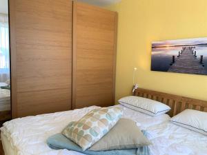 a bedroom with a bed with two pillows on it at Haus Fischerstrand - Fewo Boje in Dahme