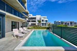 a swimming pool in the backyard of a house at Pure in Medulin