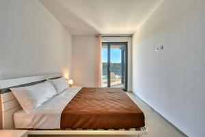 a bedroom with a bed and a large window at Pure in Medulin +42 photos
