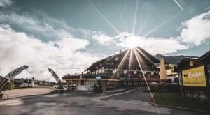 a building with the sun shining on top of it at Appartementhaus Am Gschwandtkopf in Seefeld in Tirol