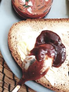 a piece of bread with chocolate sauce on a plate at Aretousa Deluxe Downtown Apartment in Skala