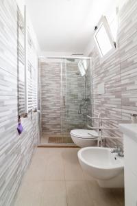 Un baño con dos lavabos y una ducha. en Palazzo Fiordaliso - Puglia Mia Apartments, en Monopoli 38 fotos más