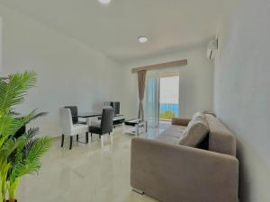 a living room with a couch and a table at Seaside Apartments Sword in Bar