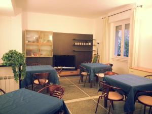 jadalnia ze stołami i krzesłami z niebieskimi narzutami w obiekcie Hotel Mignon Posta w Rapallo