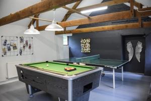a room with a pool table and ping pong ball at Lower Trengale Farm Holiday Cottages in Liskeard