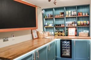 a kitchen with a counter with a blackboard on the wall at Lower Trengale Farm Holiday Cottages in Liskeard