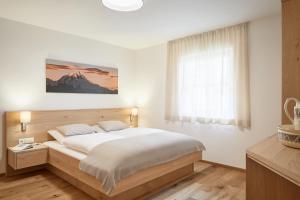 Postel nebo postele na pokoji v ubytování daHoam Appartamenti + 2 fotografie