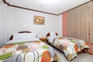 Postel nebo postele na pokoji v ubytování Hostal Rossy