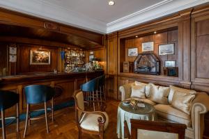 a living room with a couch and a bar at Excelsior Palace Portofino Coast in Rapallo