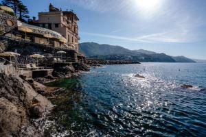 a building on the side of a body of water at Excelsior Palace Portofino Coast in Rapallo